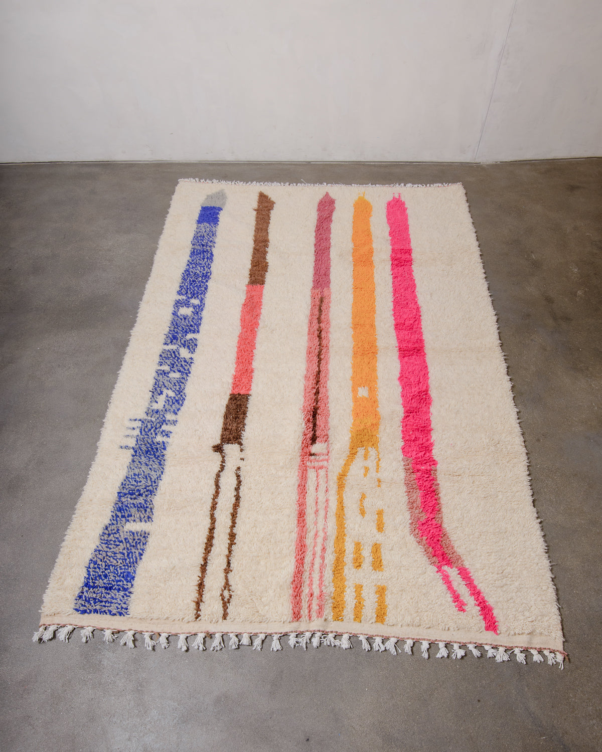 Berberlin Azilal rug made of sheep’s wool laying on concrete floor.
